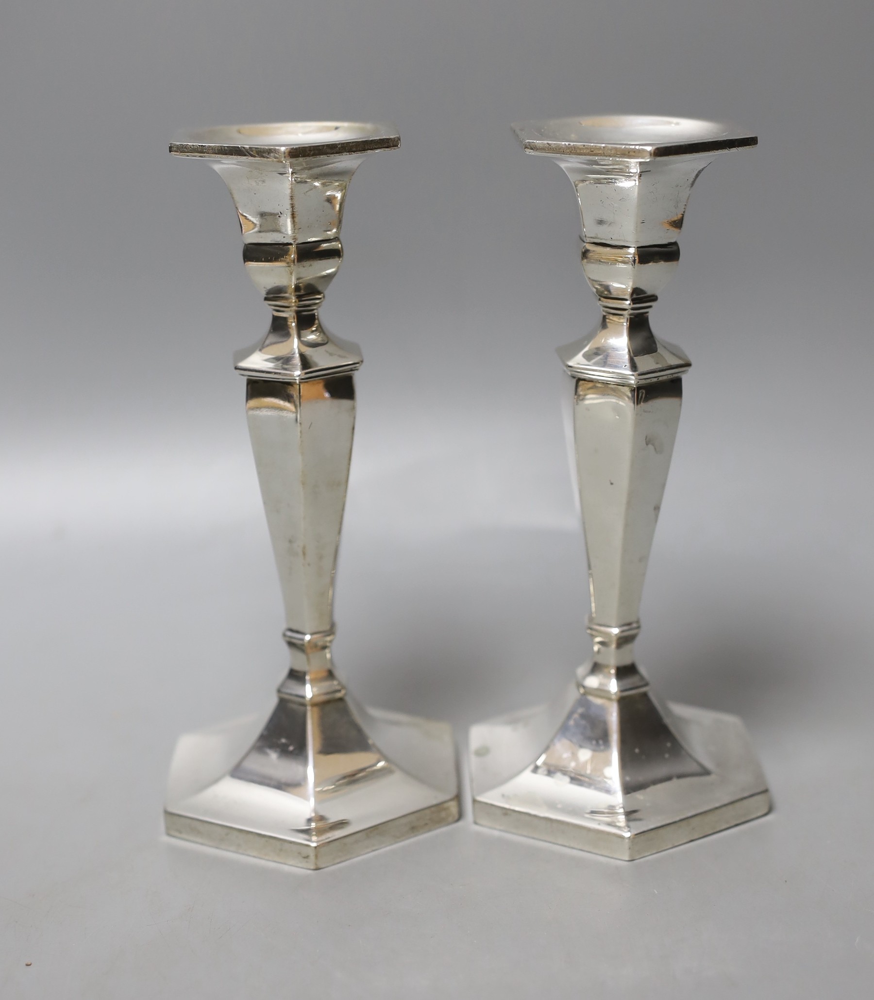 A pair of sterling hexagonal candlesticks, maker L.H?, 17.5cm, gross 561 grams.